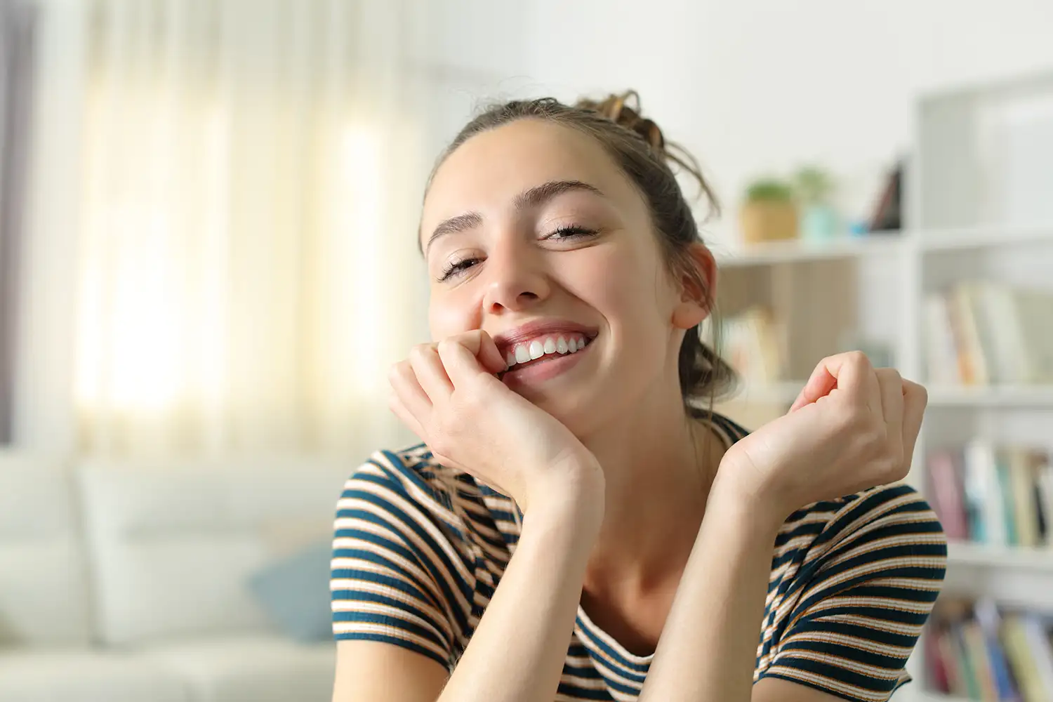 smiling young adult woman with flawless skin and perfect teeth