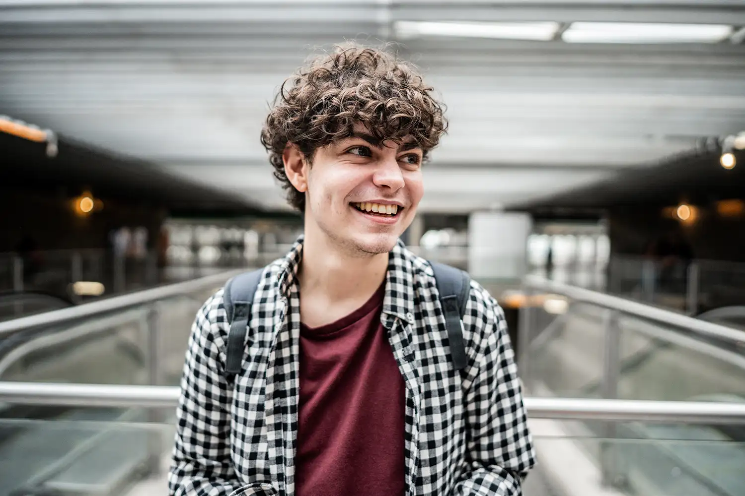 young adult smiling in a mall