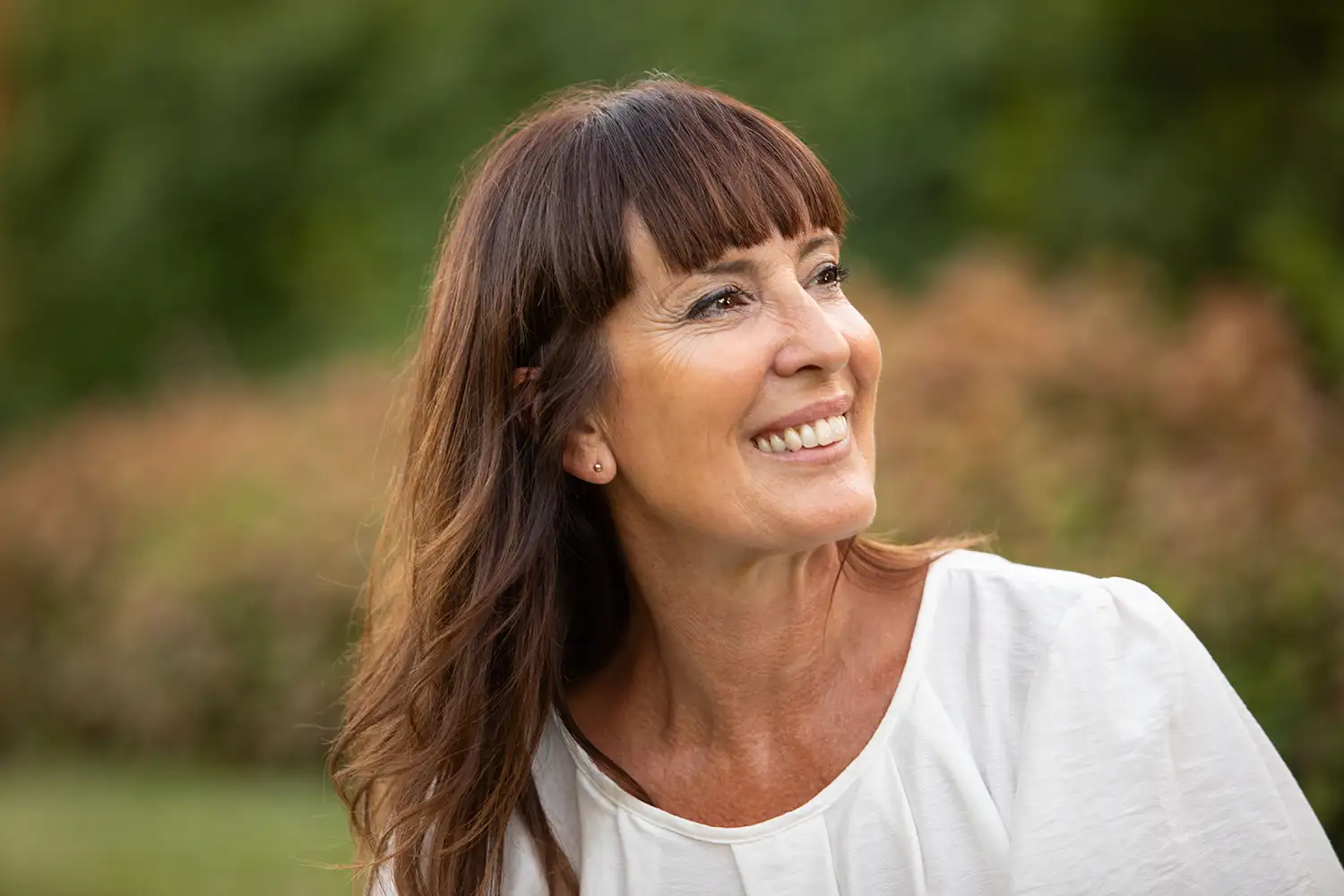 mature woman with great skin smiling outdoors