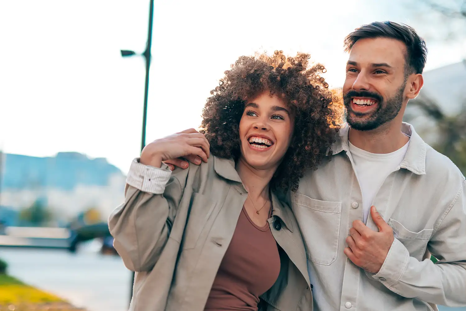 mixed race couple embracing and smiling