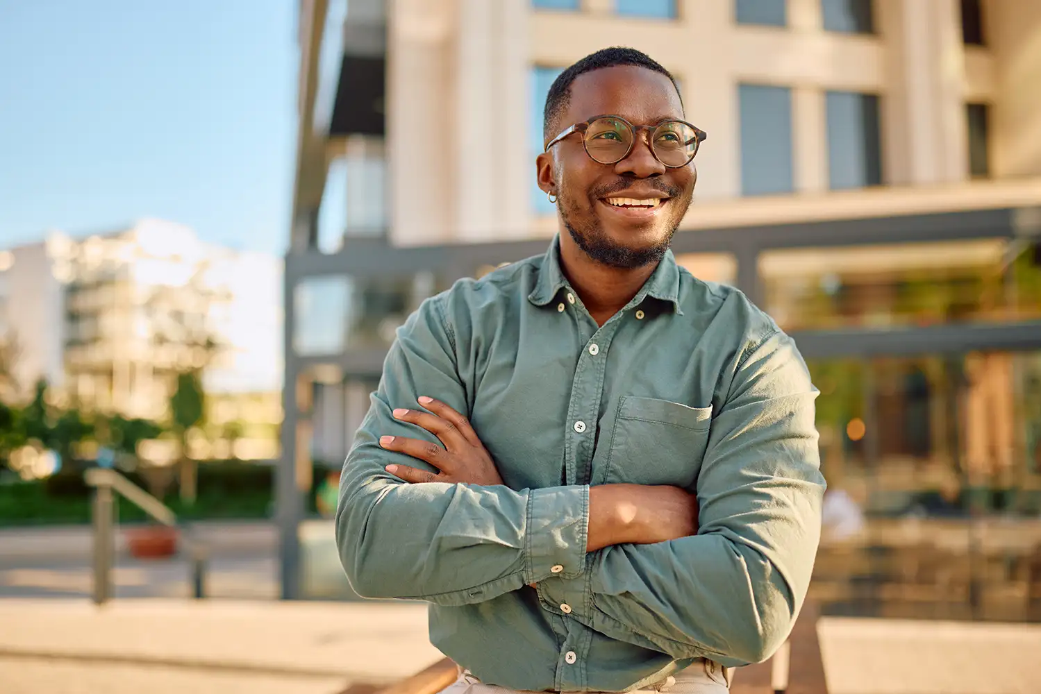 middle age business man smiling with his arms crossed