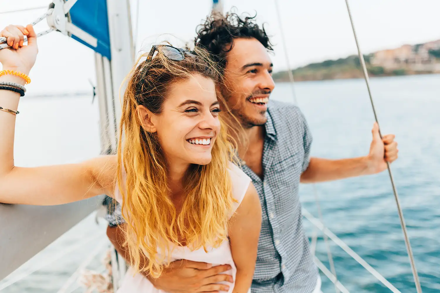 young couple on a sail boat and smiling
