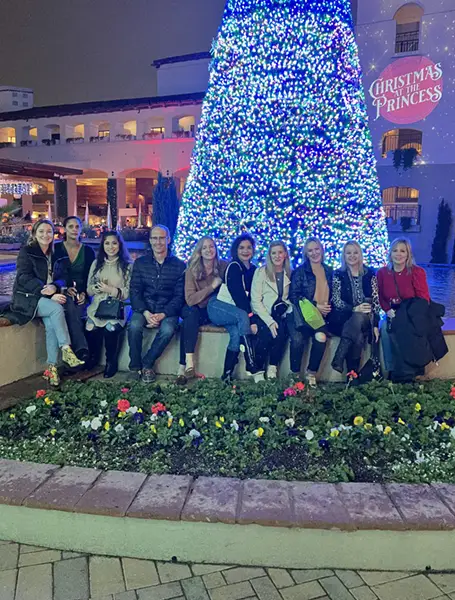 The Pogue Center staff in front of a Christmas tree in Scottsdale, AZ
